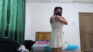 The busty executive chooses a white dress and then starts making sensual movements, showing her beautiful vagina 