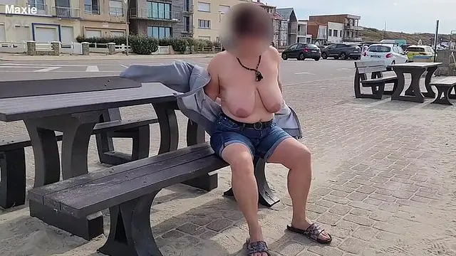 Curvy MILF exposes her big saggy boobs in the street